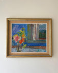 A framed vintage oil painting of a bouquet in front of a blue wall and window. Available at Hue.