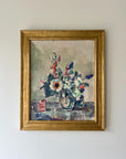A framed vintage oil painting of a bouquet of Anemones in a glass vase. Available at Hue.
