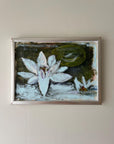 Framed vintage artwork of water lilies in a silver frame, available at Hue.