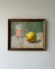 Framed vinatge oil painting of a glass and lemon. Available at Hue.