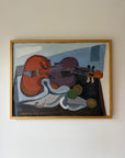 Framed vintage oil painting of a still life with a violin on a table. Available at Hue.