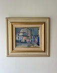 Framed vintage oil painting of a village scene with buildings. Available at Hue.