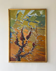 Abstract painting of tree with warm autumnal colors in a gold frame on a beige wall available from hue