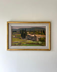Framed painting of a country green landscape with a farmhouse and trees on a white wall available from hue