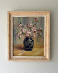 Framed painting of a blue vase with blossom flowers on a neutral, available from hue