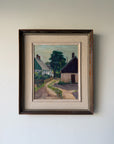 A framed vinatge landscape oil painting of a quiet village street with cottages and trees. Available at Hue.