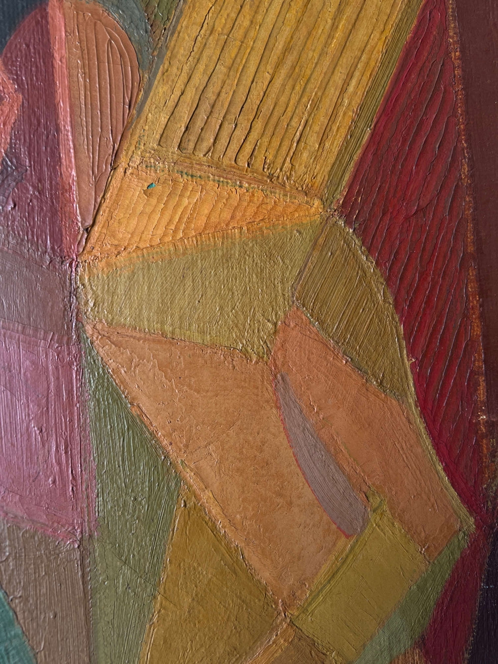 Close up of a vintage abstract oil painting of a female figure painted using geometric shapes in warm ochre colours, reminiscent of a cubist or modernist style.