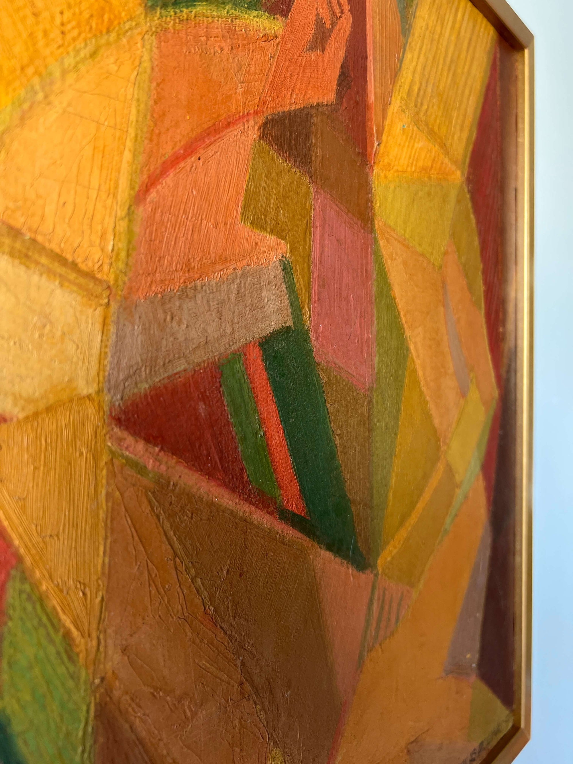 Close up of a vintage abstract oil painting of a female figure painted using geometric shapes in warm ochre colours, reminiscent of a cubist or modernist style.