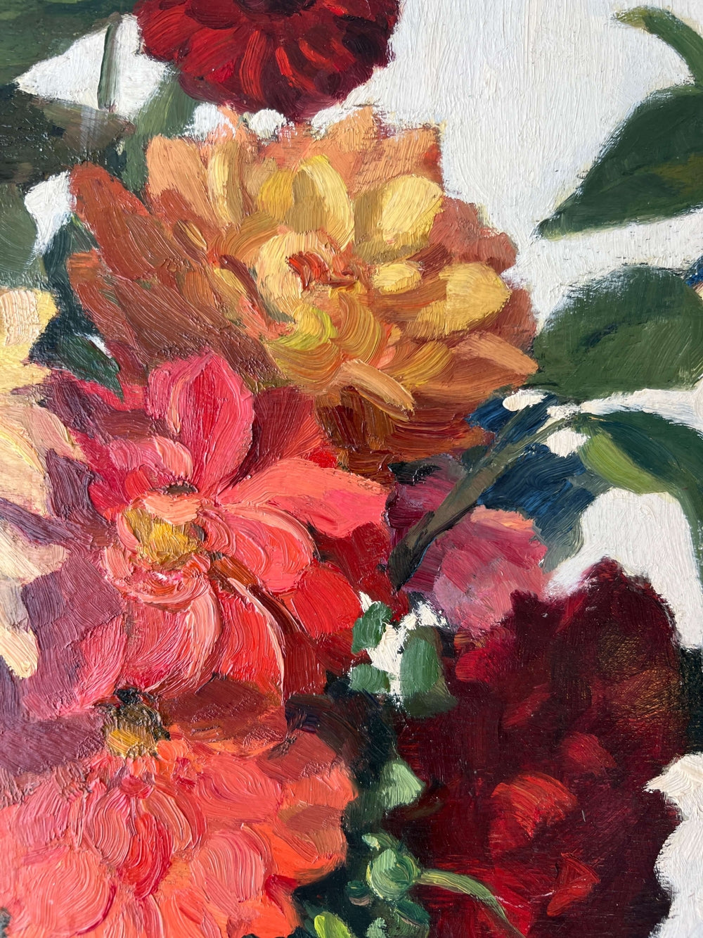 Framed, vintage, still life oil painting of a bouquet of red flowers.