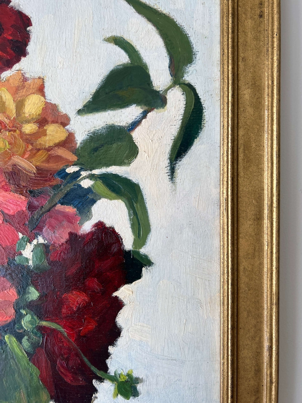 Framed, vintage, still life oil painting of a bouquet of red flowers.