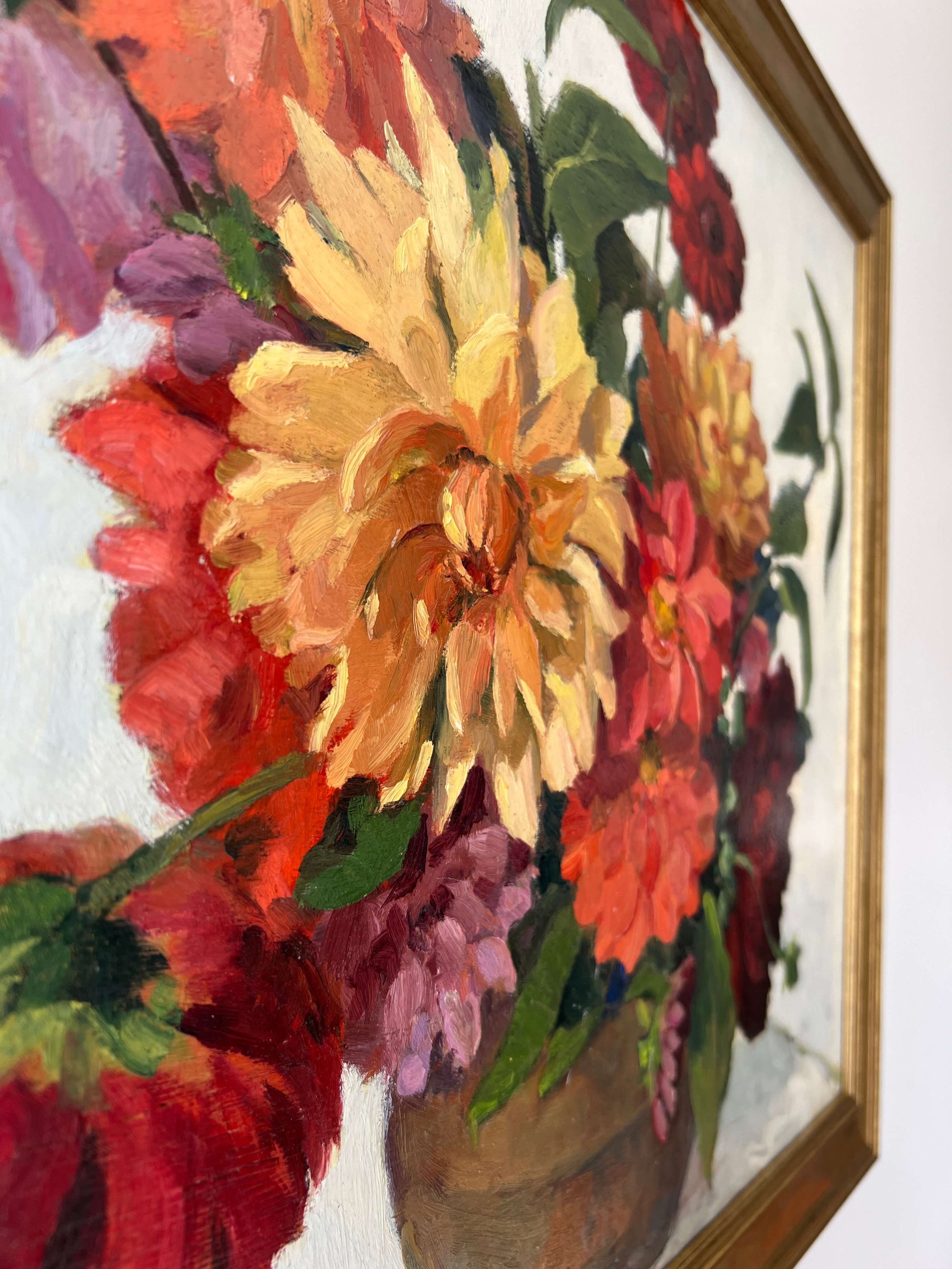 Framed, vintage, still life oil painting of a bouquet of red flowers.