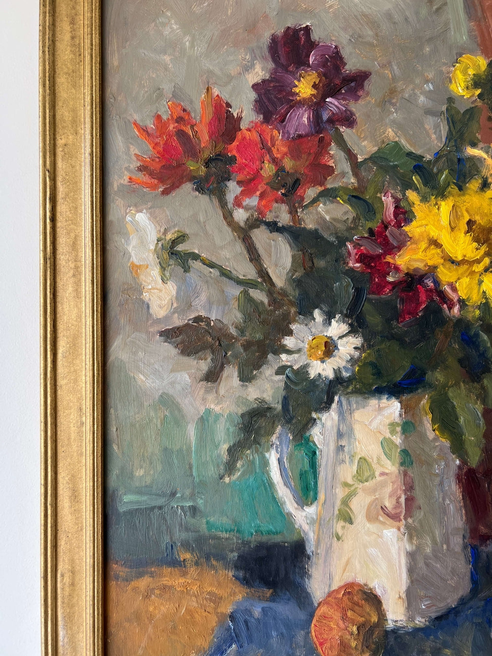 Close up of a framed impressionist oil painting on board of a bouquet of flowers with fruit. Still life art.