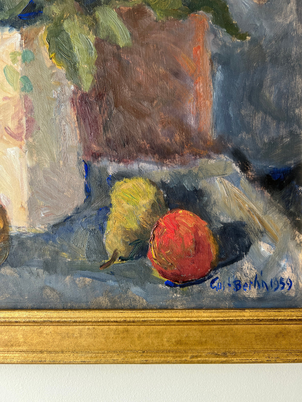 Close up of a framed impressionist oil painting on board of a bouquet of flowers with fruit. Still life art.