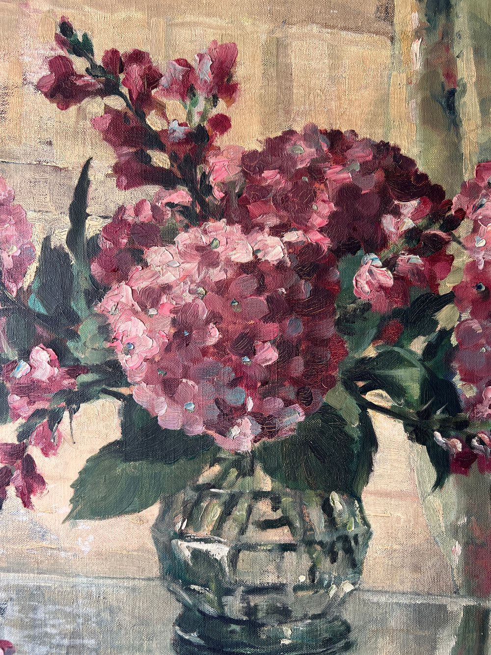 Close up of a vintage oil painting on canvas of a bouquet of dark pink hydrangeas in a glass vase. 
