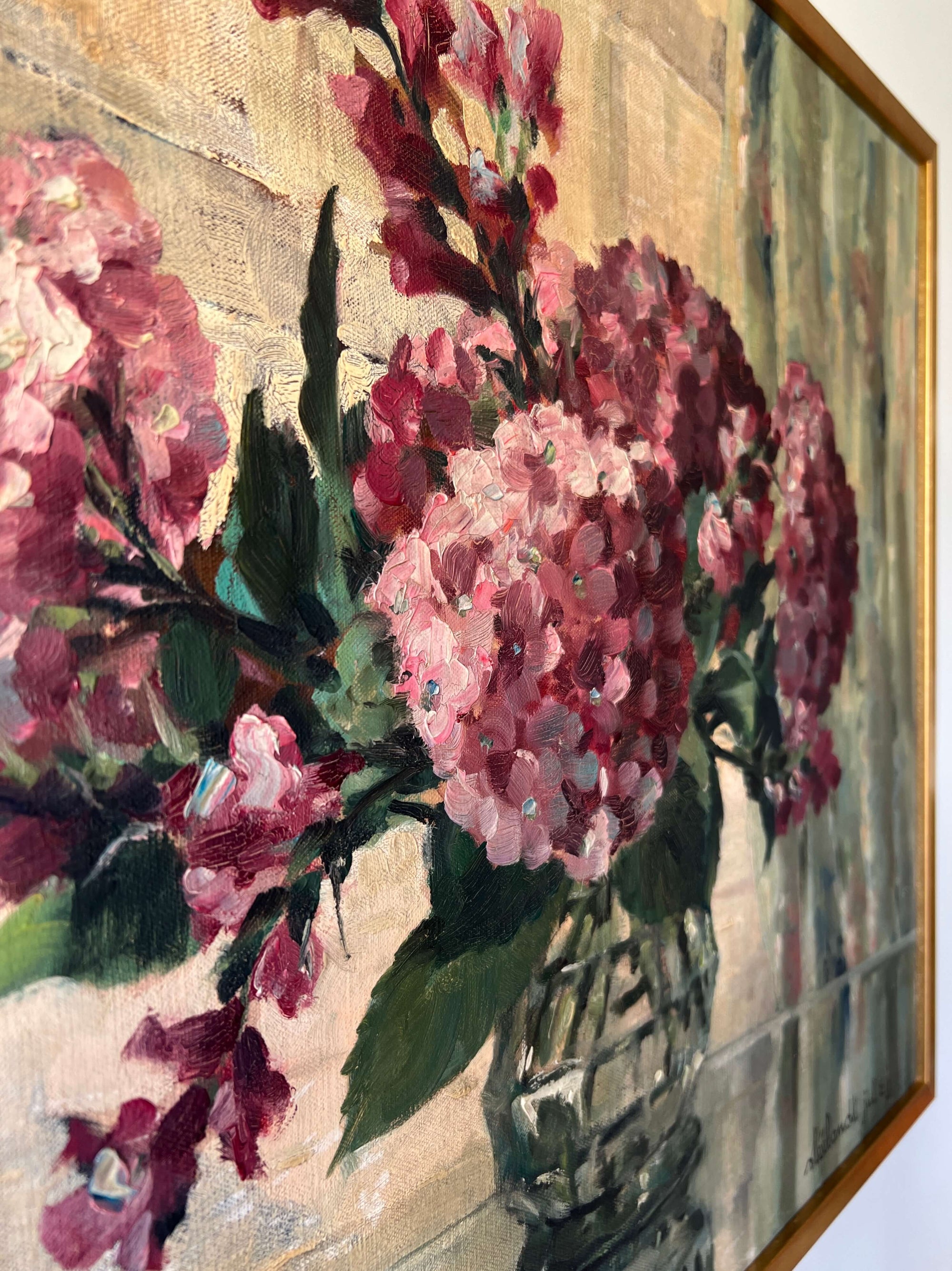 Close up of a vintage oil painting on canvas of a bouquet of dark pink hydrangeas in a glass vase. 