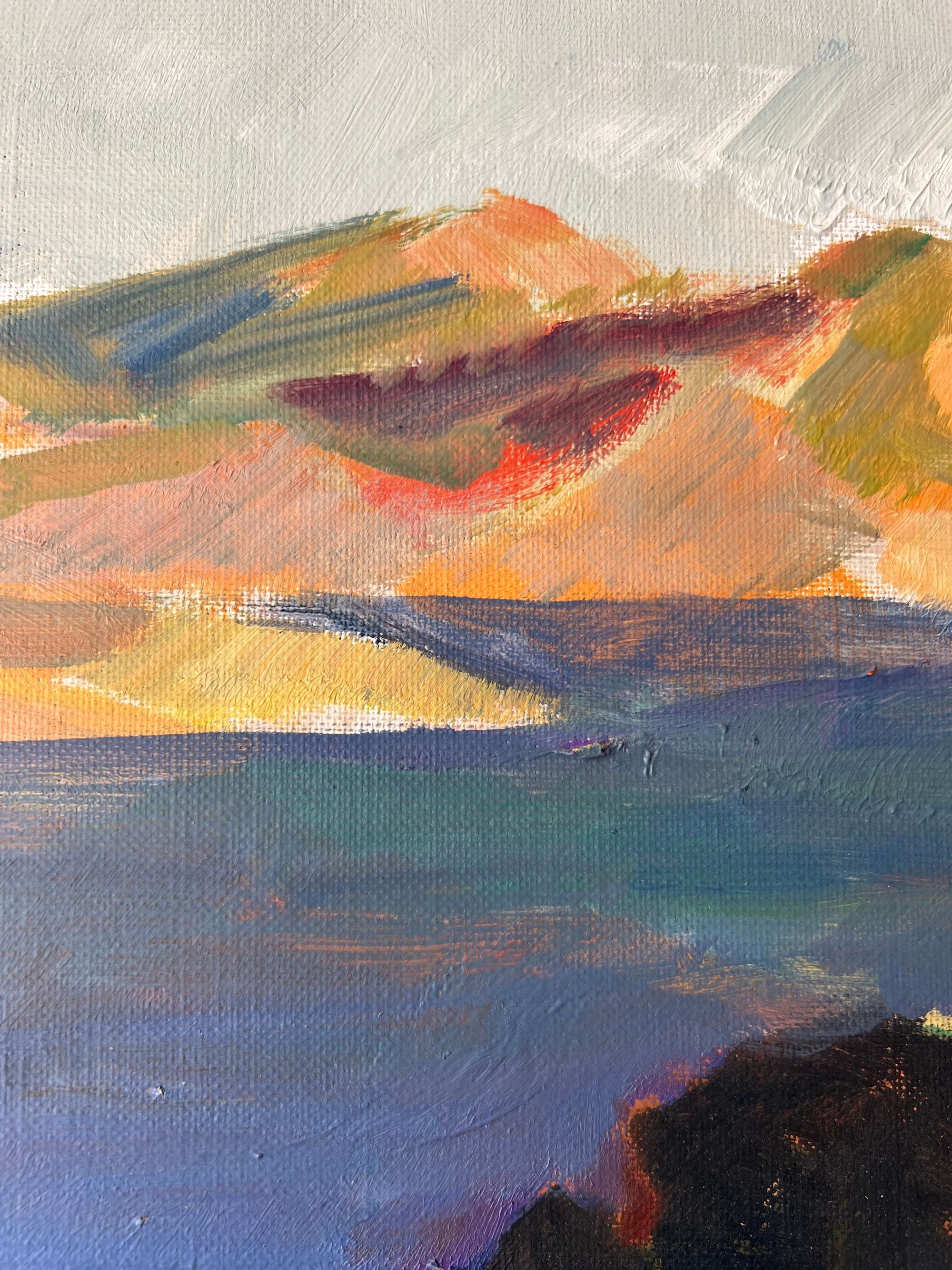Close up of a framed, vintage oil painting on canvas of a mountainous coastal landscape with houses. Impressionist style.