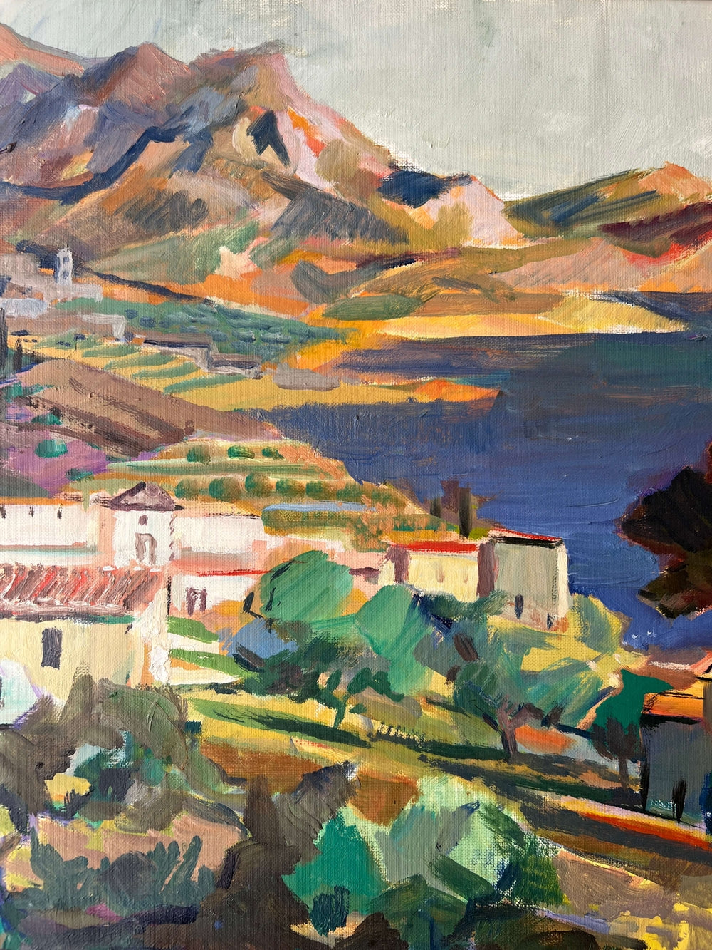 Close up of a framed, vintage oil painting on canvas of a mountainous coastal landscape with houses. Impressionist style.