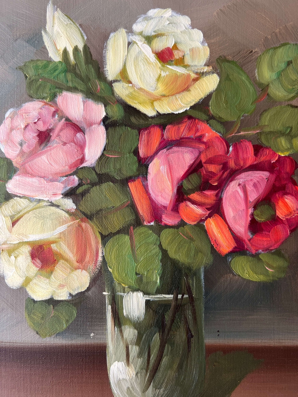 Framed, vintage artwork of roses in a glass vase. Impressionist oil painting.