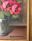 Framed, vintage artwork of roses in a glass vase. Impressionist oil painting.