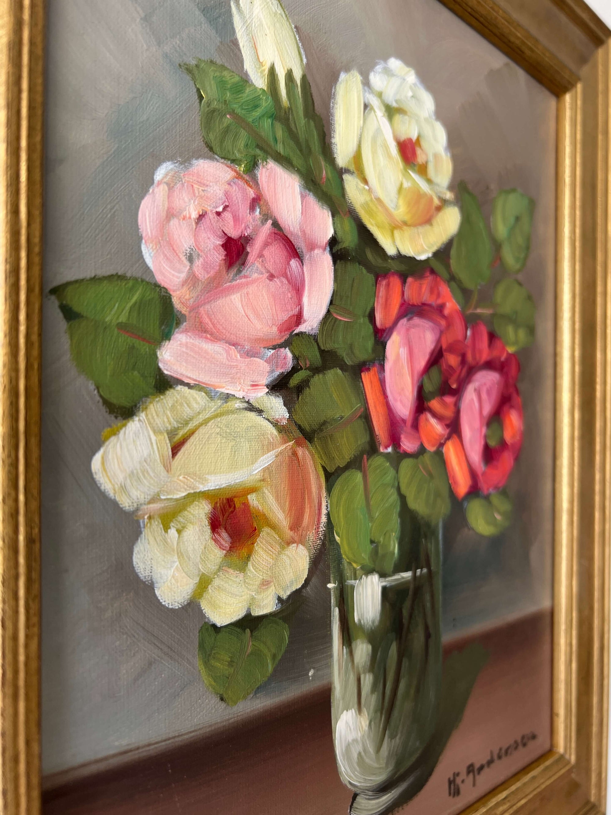 Framed, vintage artwork of roses in a glass vase. Impressionist oil painting.
