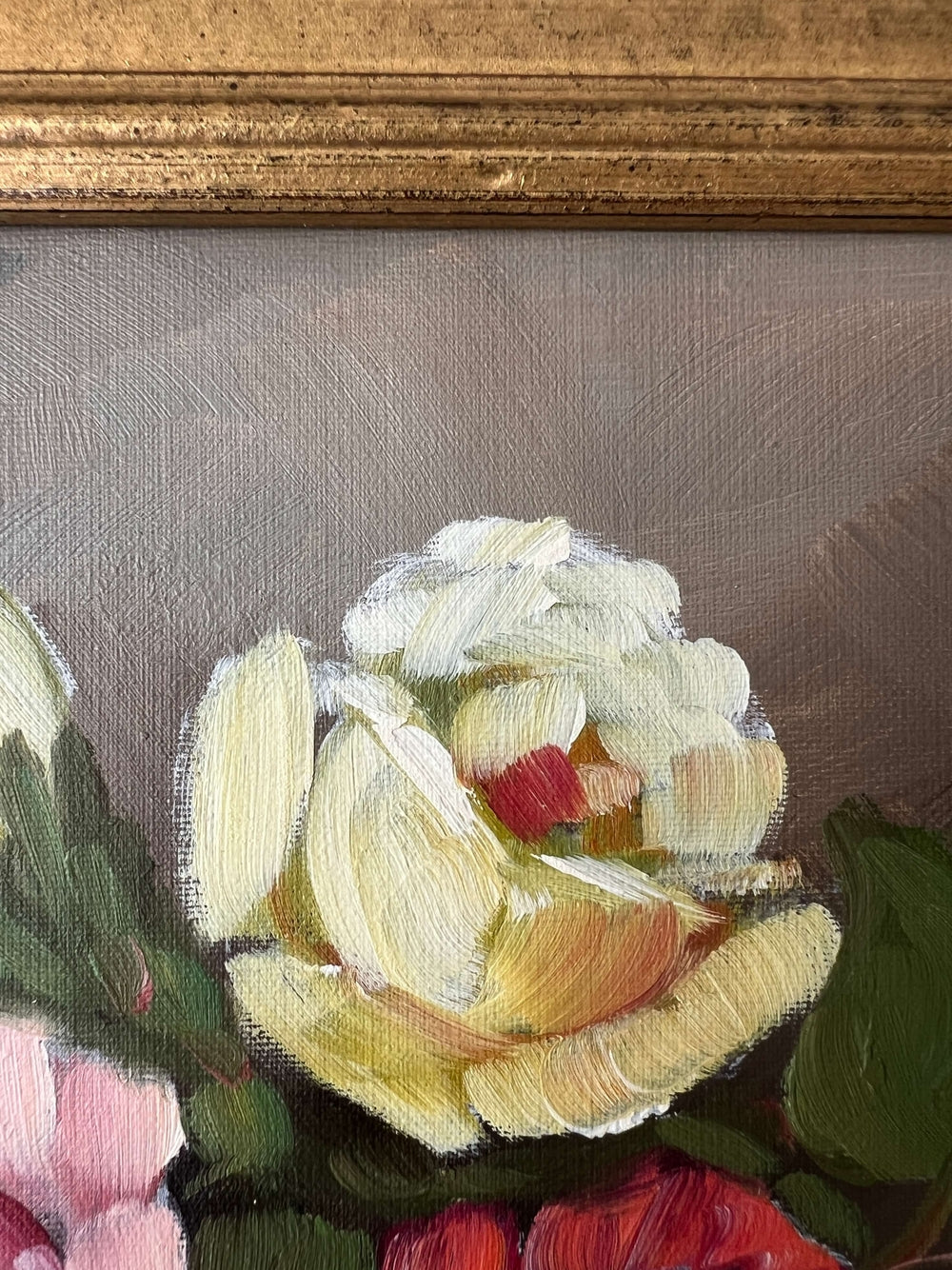 Framed, vintage artwork of roses in a glass vase. Impressionist oil painting.
