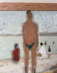 Close up of a framed artwork of a beach scene with figures