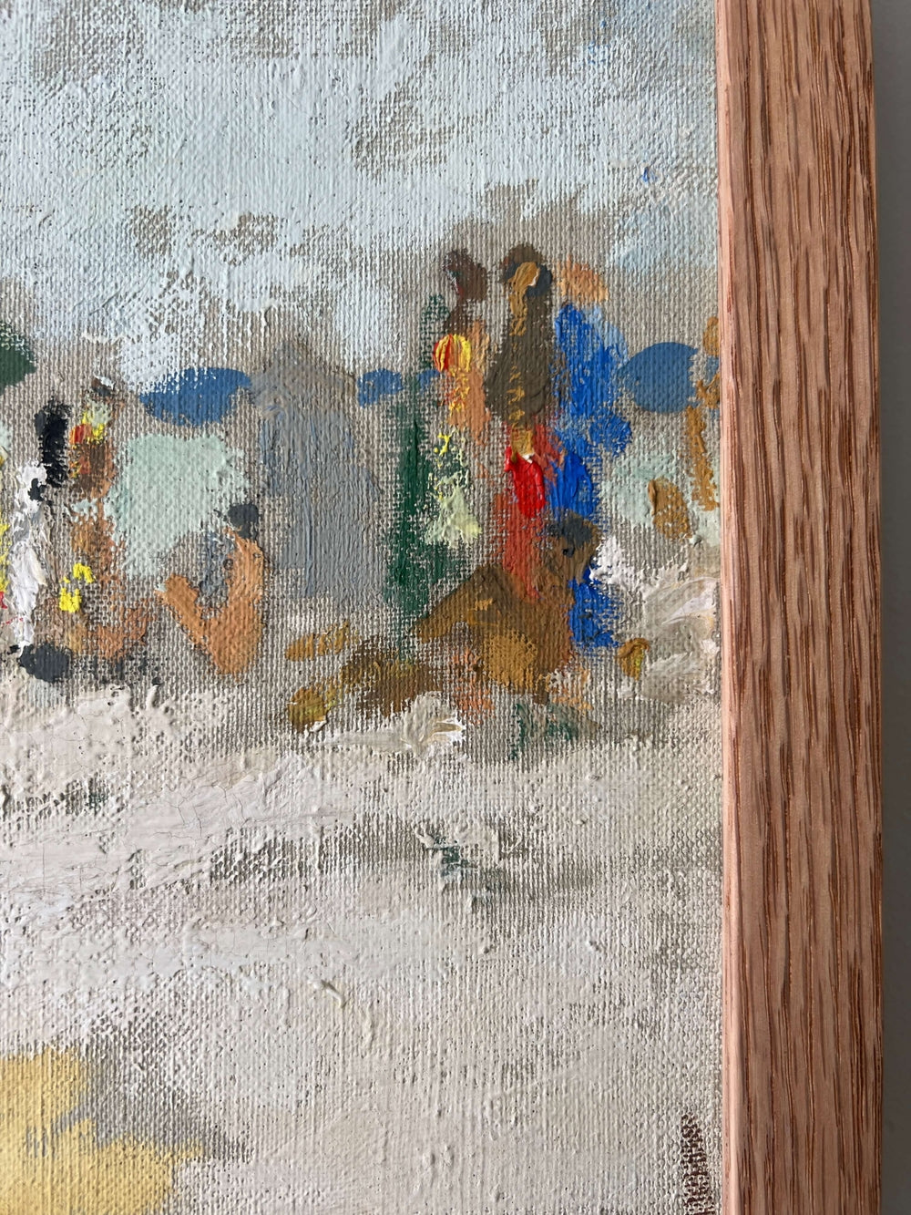 Close up of a framed artwork of a beach scene with figures