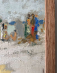 Close up of a framed artwork of a beach scene with figures