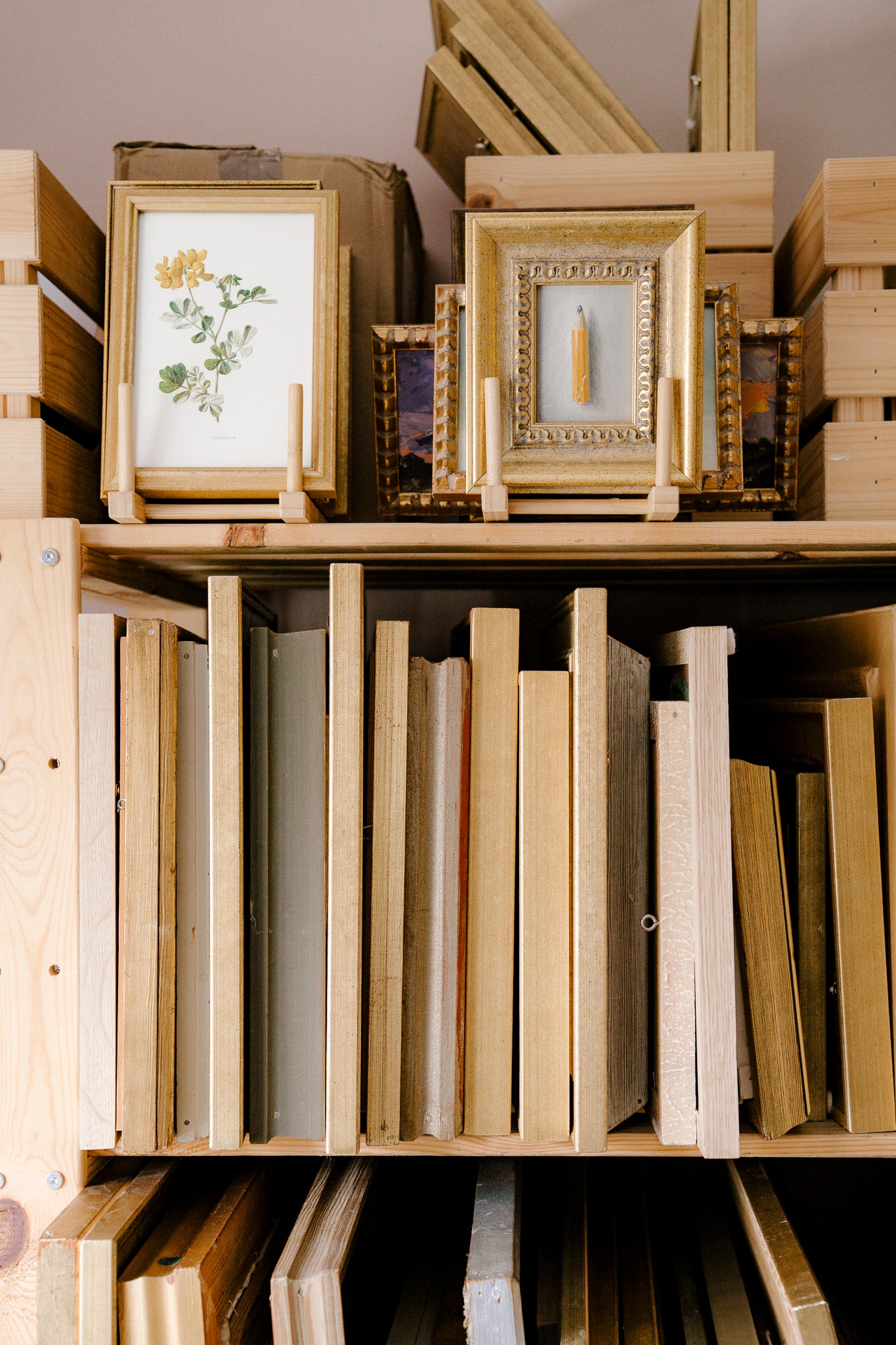 Wooden shelf with framed vintage pictures and books