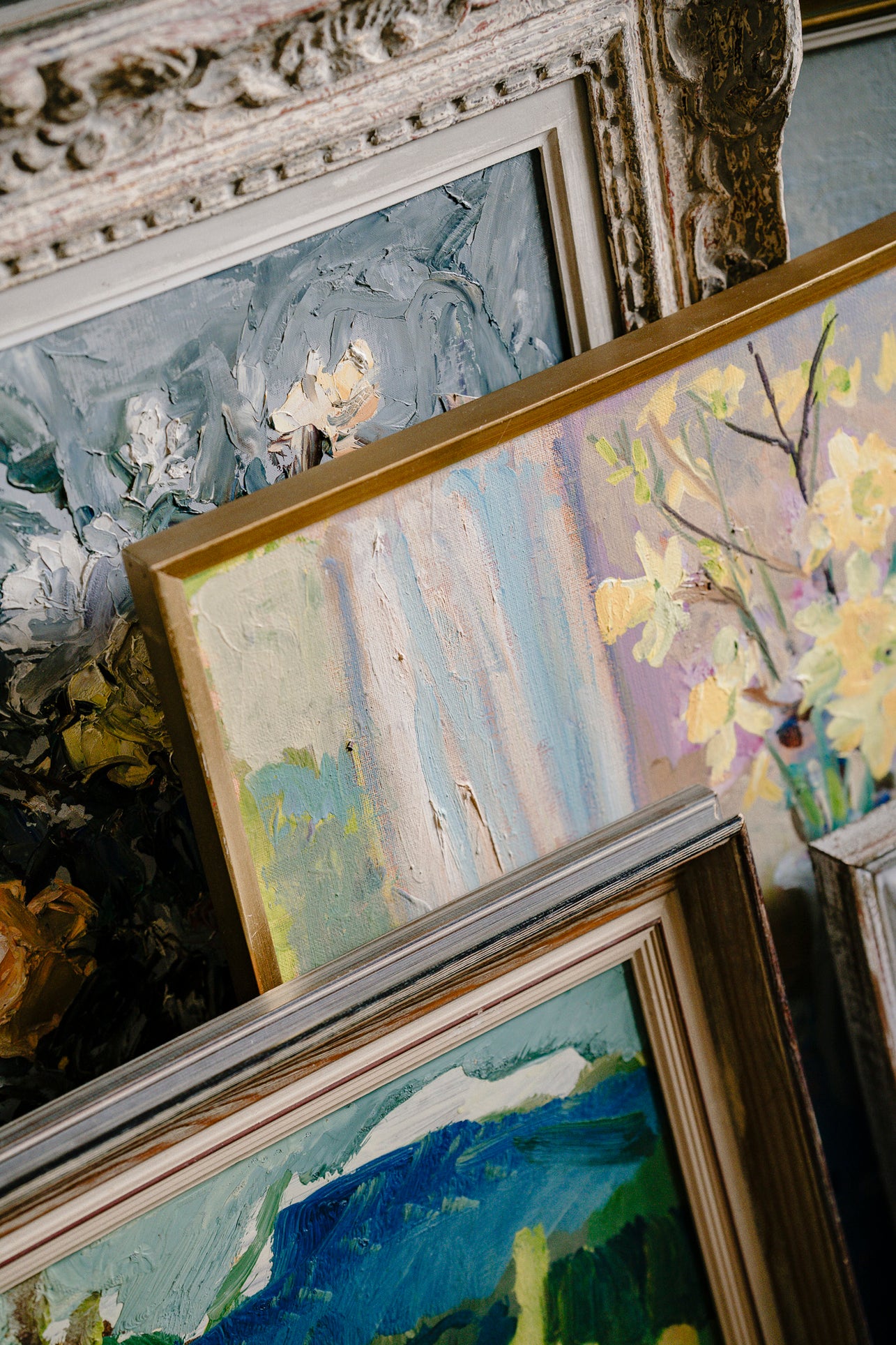 Close-up of framed vintage paintings with detailed artwork