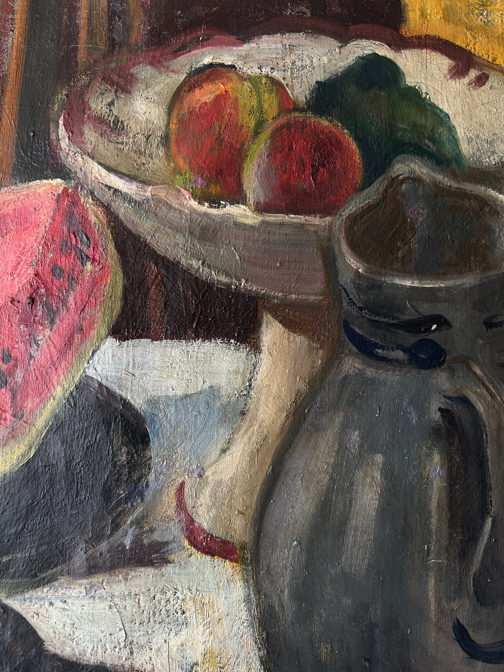 Close up of a framed still life oil vintage painting with watermelon, fruit, and jug on a table.