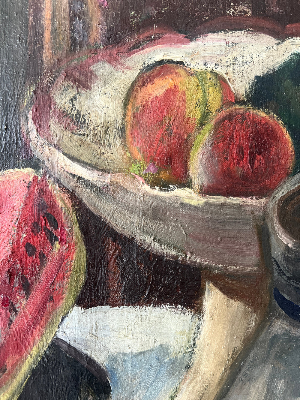 Close up of a framed still life oil vintage painting with watermelon, fruit, and jug on a table.