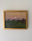 A framed vintage landscape oil painting from the mid-century. The painting depicts a green field under a warm, sunset-coloured sky with a glowing sun and distant hills, enclosed in a gold frame. Available at Hue.