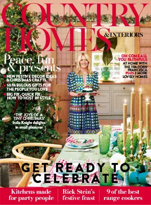 Country Homes & Interiors magazine cover featuring a festive Christmas dining room with decorated tree, candles and colourful table setting.