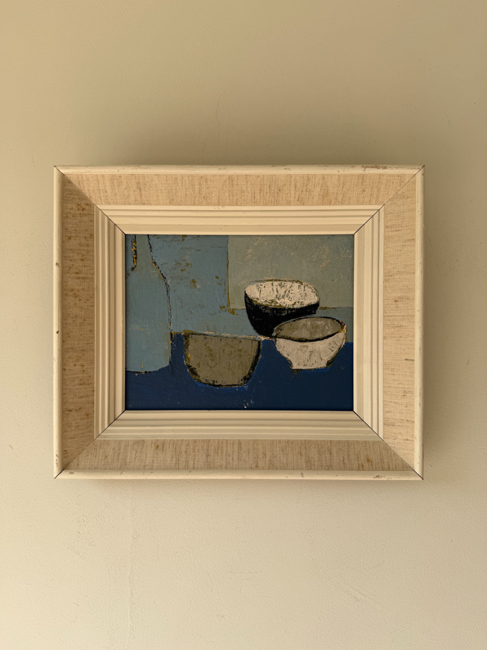 A framed abstract oil painting featuring blue, beige, and black geometric shapes and bowl-like forms. Available at Hue.