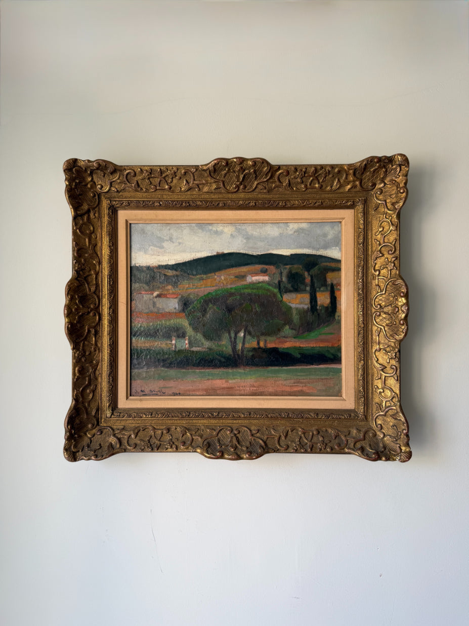 A vinatge oil landscape painting in an ornate, carved gold frame. Available at Hue.