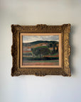 A vinatge oil landscape painting in an ornate, carved gold frame. Available at Hue.