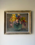 A large framed vintage still life oil painting of colourful florals in a green round vase. Available at Hue. 