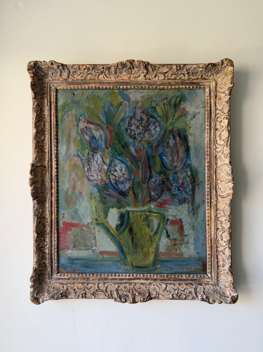 A vintage oil painting of a floral bouquet in a green pitcher, housed in an ornate, carved antique-style gold frame. Available at Hue.