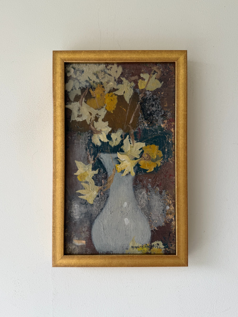 A framed vintage still life oil painting of a white vase with yellow and white flowers. Available at Hue. 