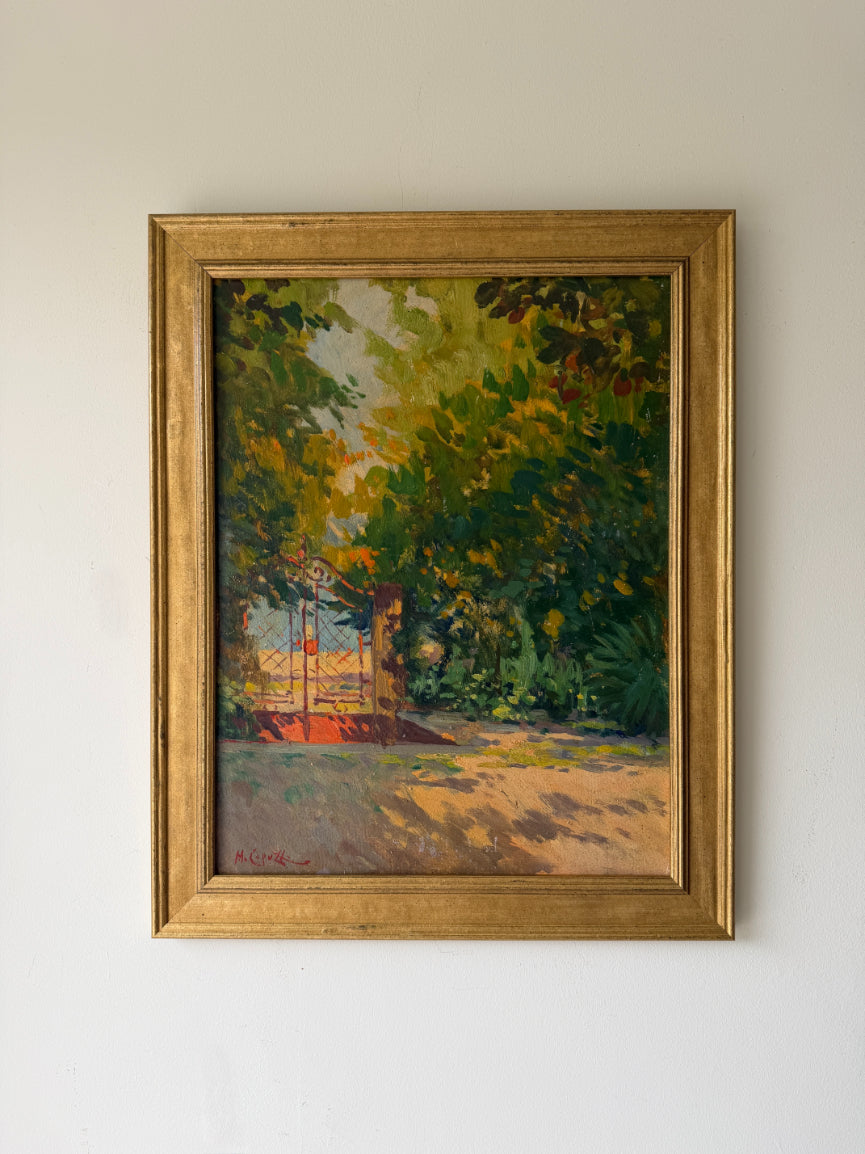 A framed vintage impressionist landscape oil painting depicting a sunlit garden path through dense green and yellow foliage leading to a red gate. Available at Hue. 