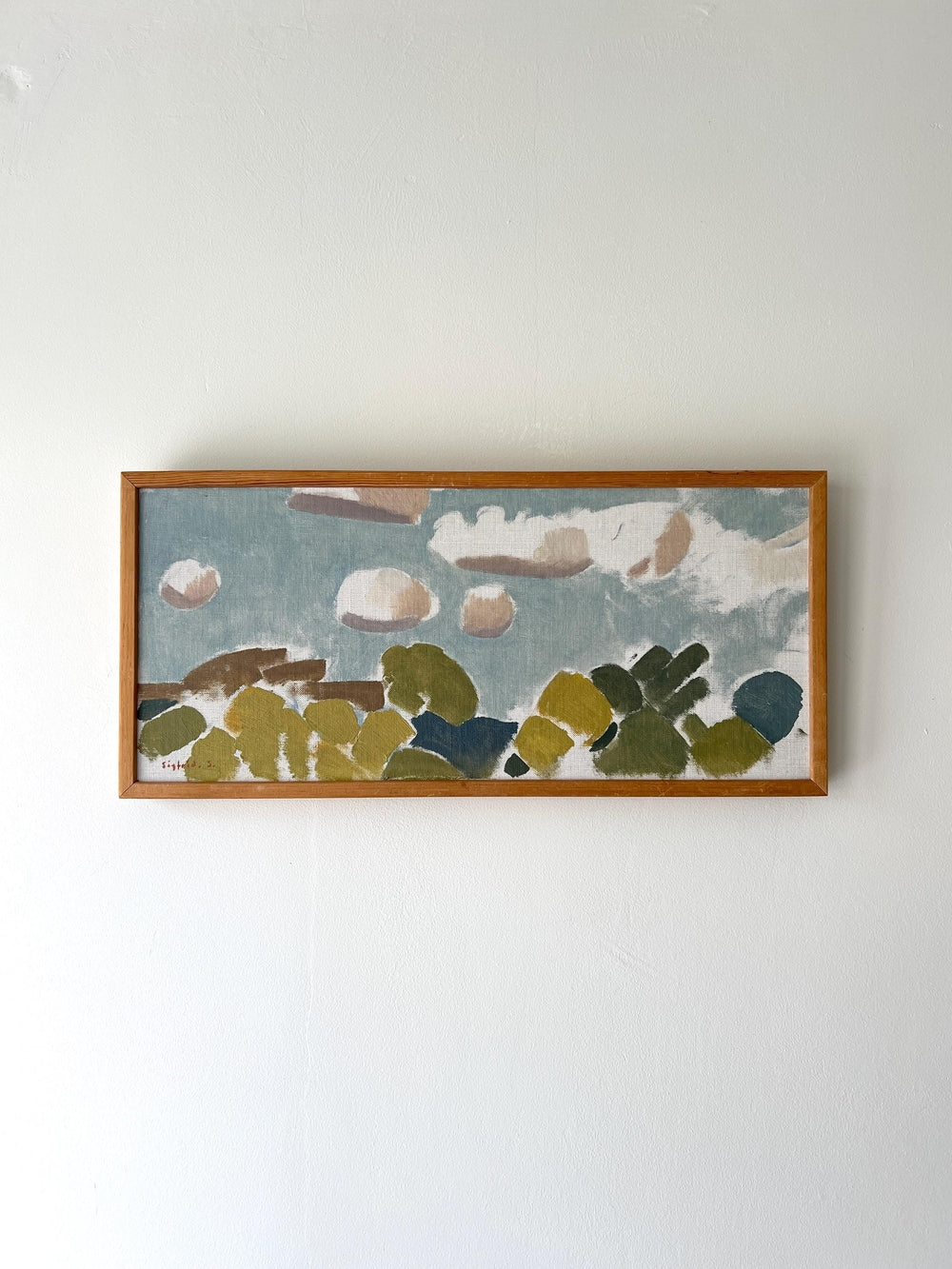 Framed abstract artwork with green, blue, and brown cloud shapes, available from hue