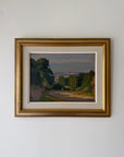 Framed vintage oil landscape painting of trees and a distant village. Available at Hue. 