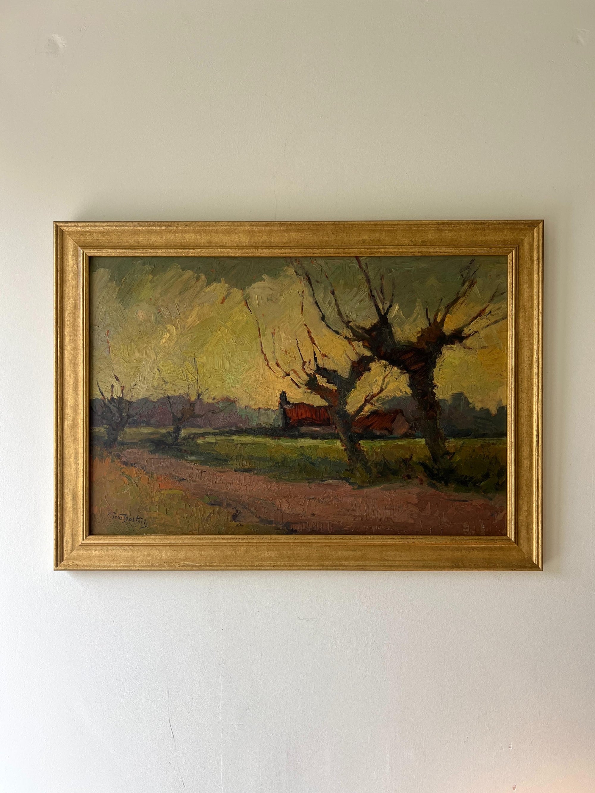 A framed vintage oil painting of a rustic landscape with bare willow trees. Available at Hue. 