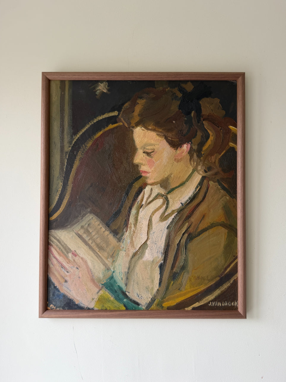 Framed vintage oil painting of a woman reading a book. Available at Hue. 