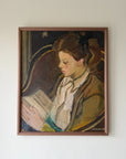 Framed vintage oil painting of a woman reading a book. Available at Hue. 