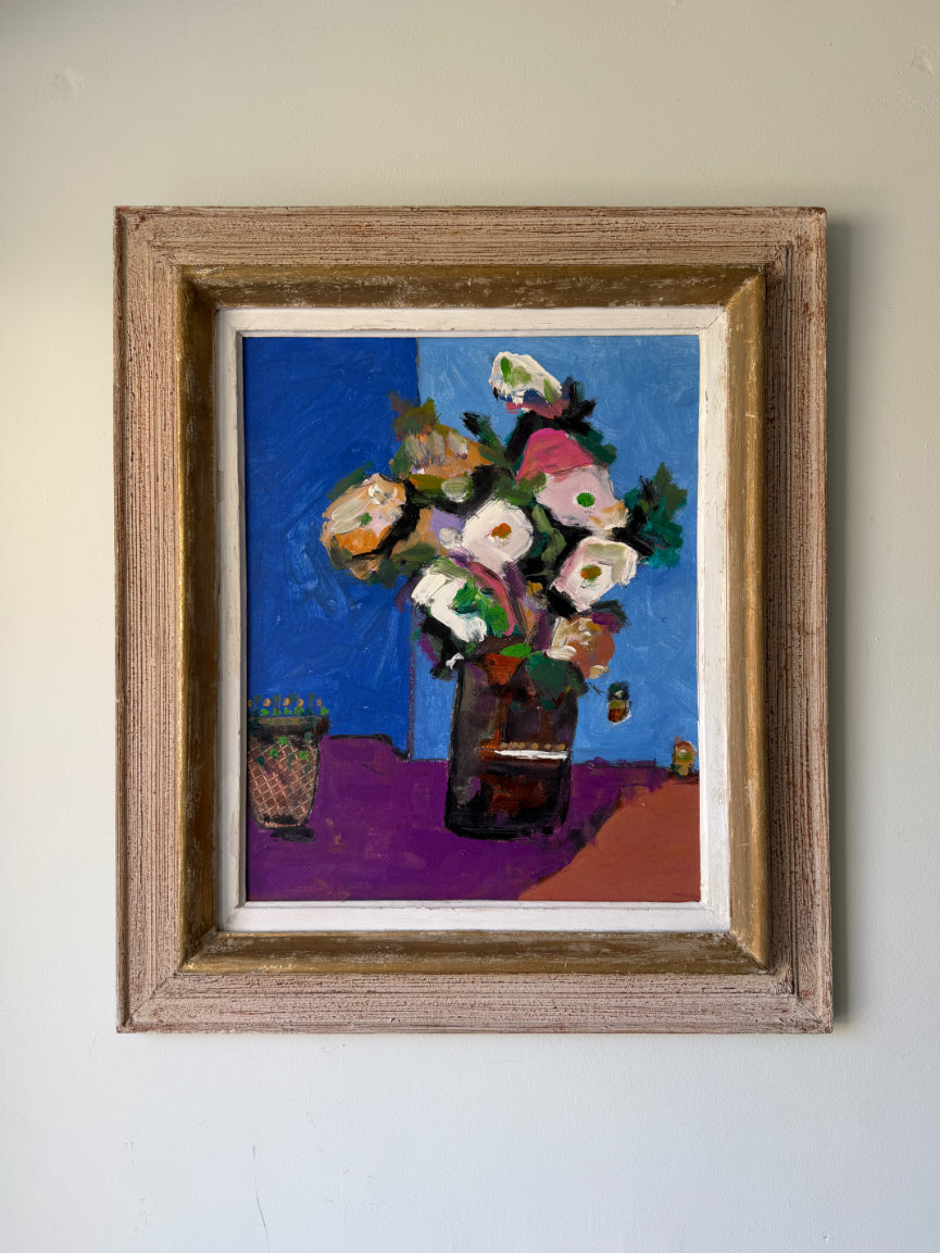 A framed still life painting of a flower bouquet in a dark vase against a blue background. Available at Hue.