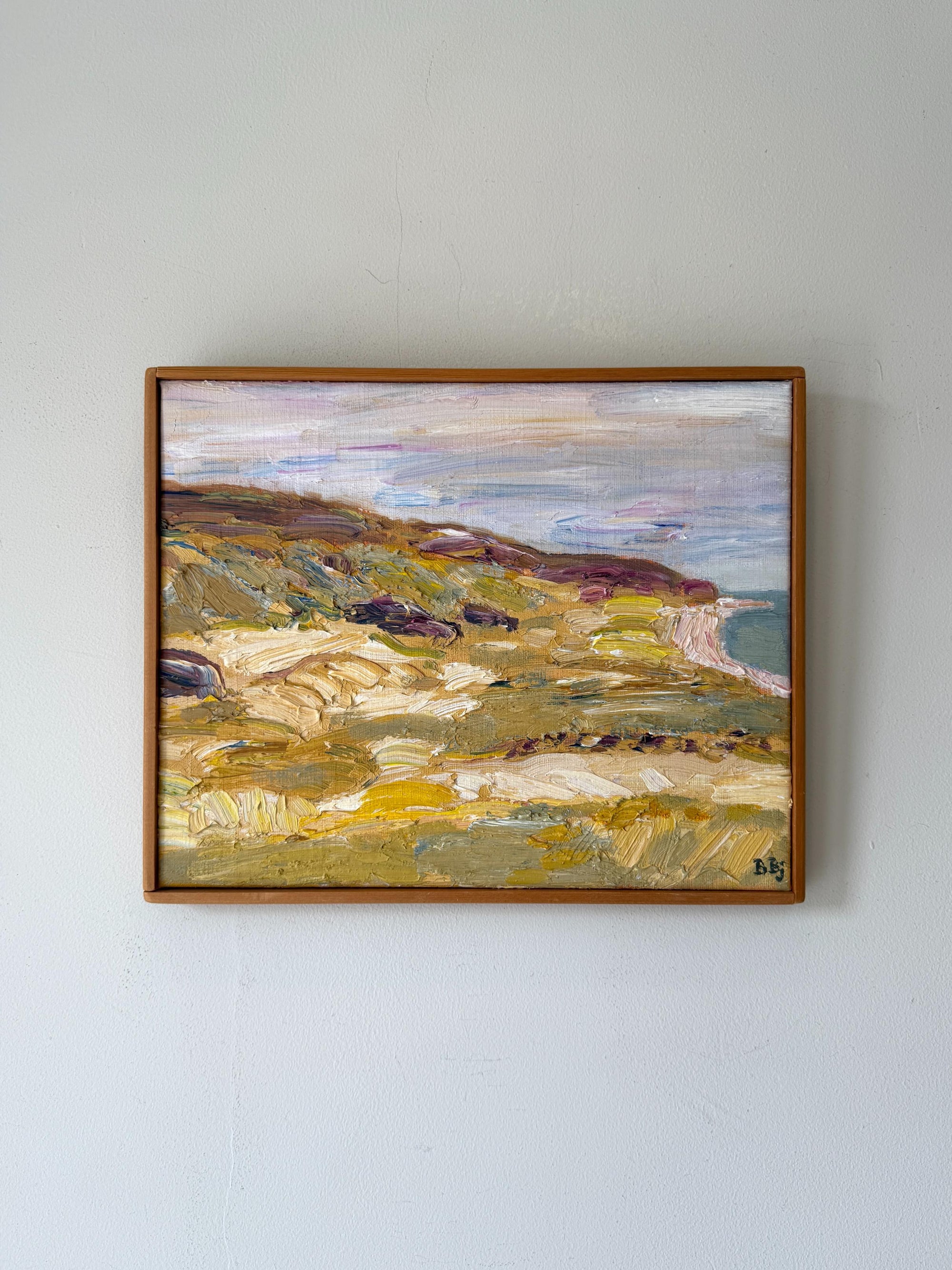 A framed vintage impressionist oil painting of a coastal landscape. Available at Hue. 