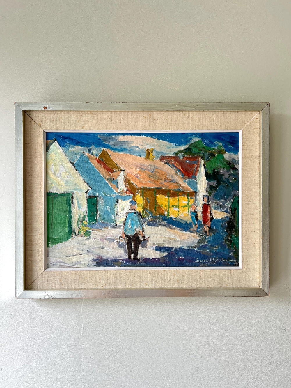 Framed vintage oil painting of a village scene with figures in a vintage frame with linen mount, available at Hue.