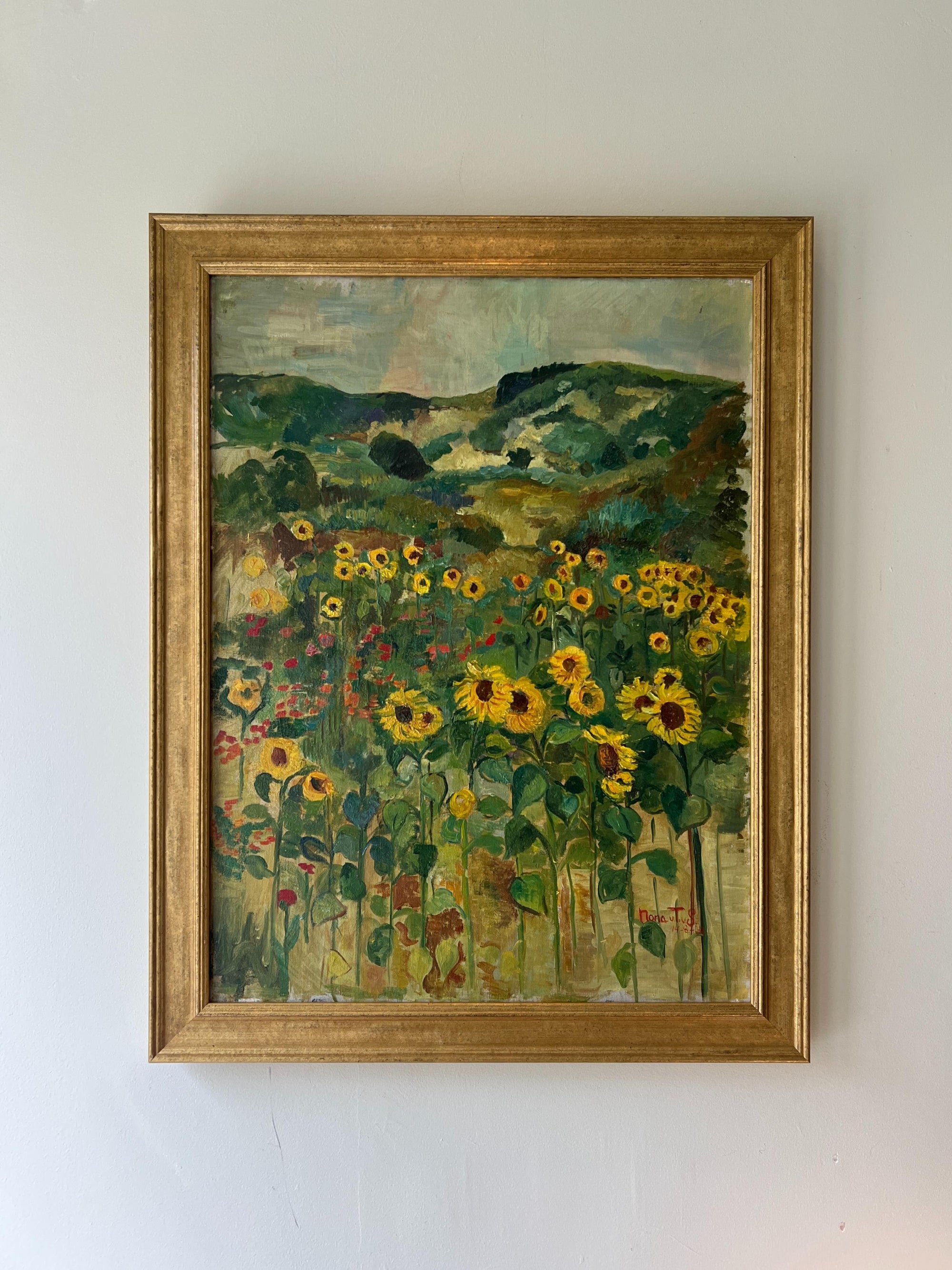 A framed vintage landscape oil painting of sunflowers in the hills. Available at Hue.
